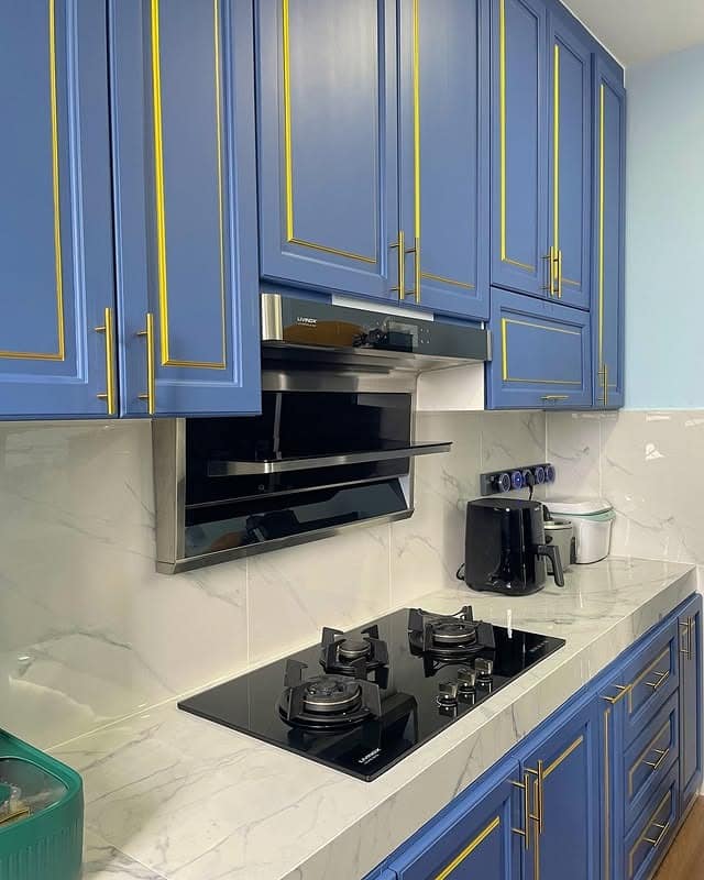 3. Royal Blue with Gold Trim Elegance - kitchen cabinet paint ideas
