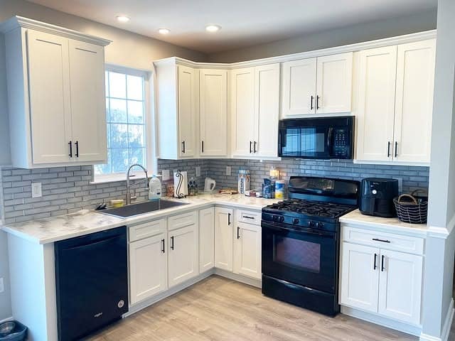 21. Bright White Cabinets with Modern Black Accents - kitchen cabinet paint ideas