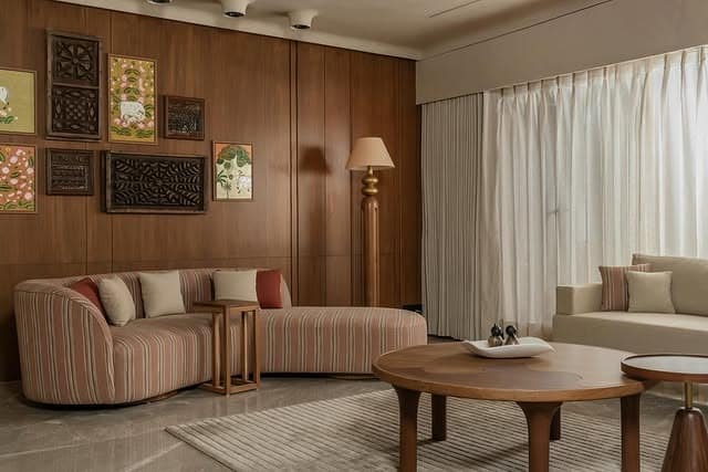 3. Striped Neutrals with Wood-Panel Elegance - indian style living room ideas