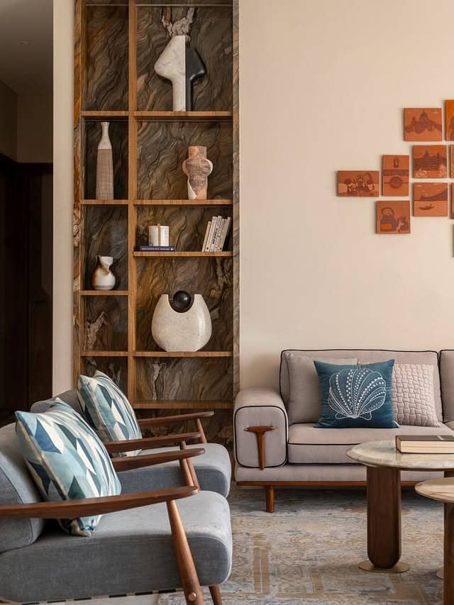 4. Sculptural Shelving with Soft Grey Seating - indian style living room ideas