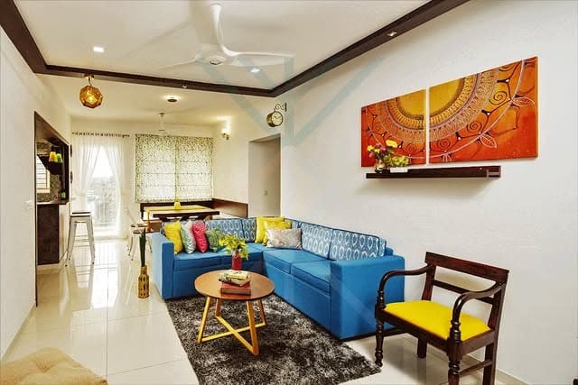12. Blue Sectional Living Room with Sunshine Tones - indian style living room ideas