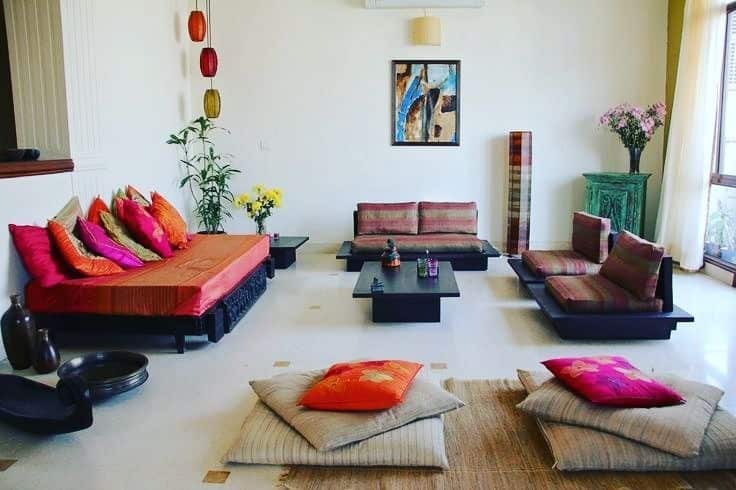 17. Floor-Style Indian Lounge with Bold Cushions - indian style living room ideas