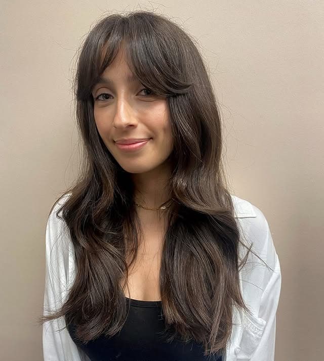 13. Long Dark Layers With Feathered Curtain Fringe - Bangs Hairstyles