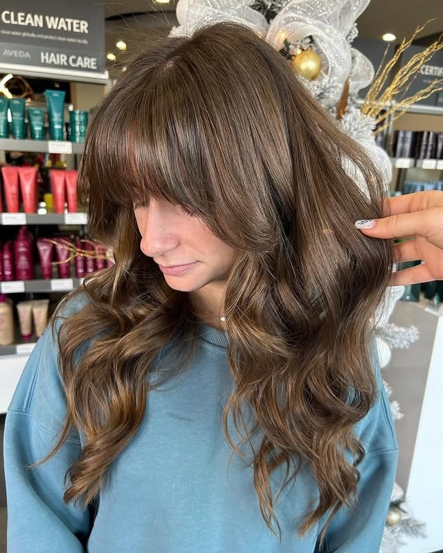 16. Glossy Chestnut Waves With Blended Full Bangs - Bangs Hairstyles