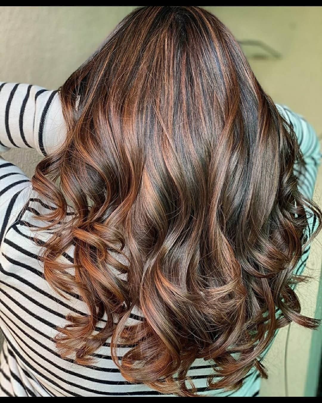 4. Caramel-Kissed Brown Curls with Luminous Contrast - Red Brown Hair with Highlights