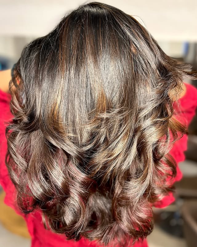 5. Brightened Chocolate Curls with Soft Copper Threads - Red Brown Hair with Highlights