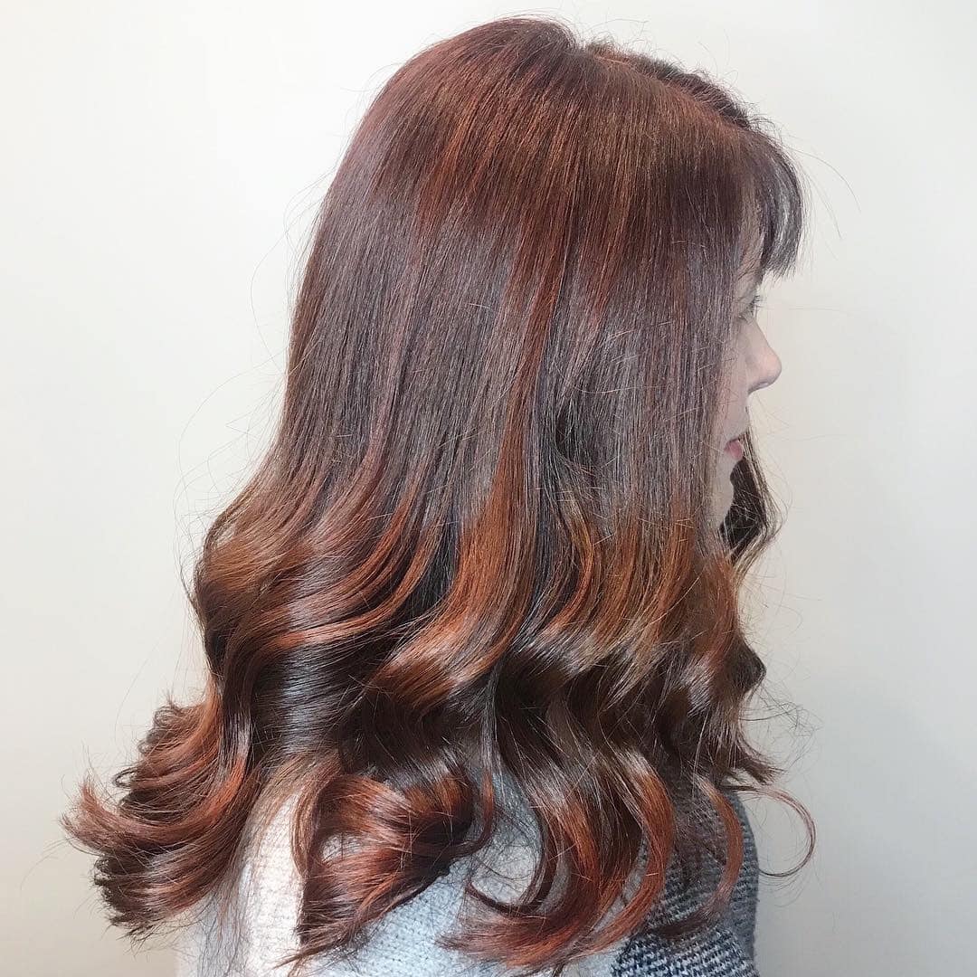 19. Glossy Red-Brown Waves with Soft Face Framing - Red Brown Hair with Highlights
