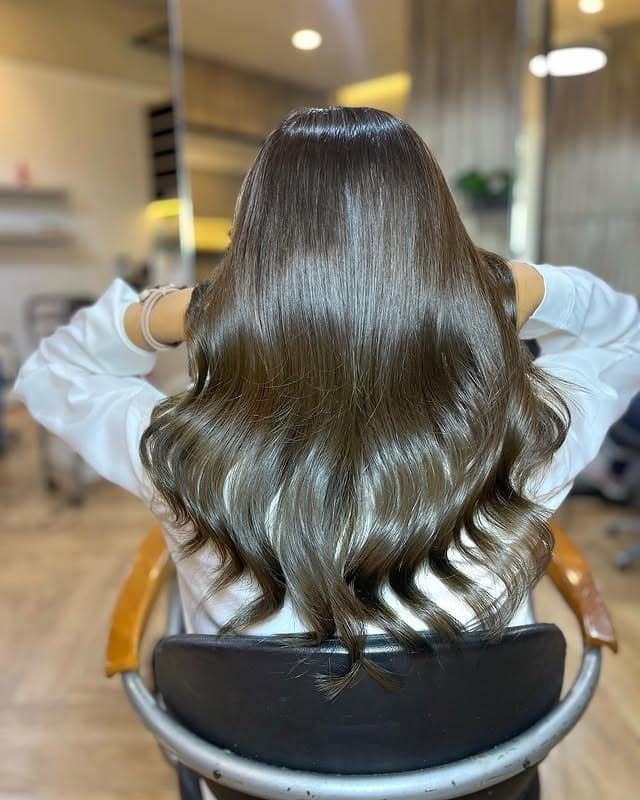 19. Soft Ash Brown Curls With Face-Framing Lift - Dark Ash Brown Hair Color