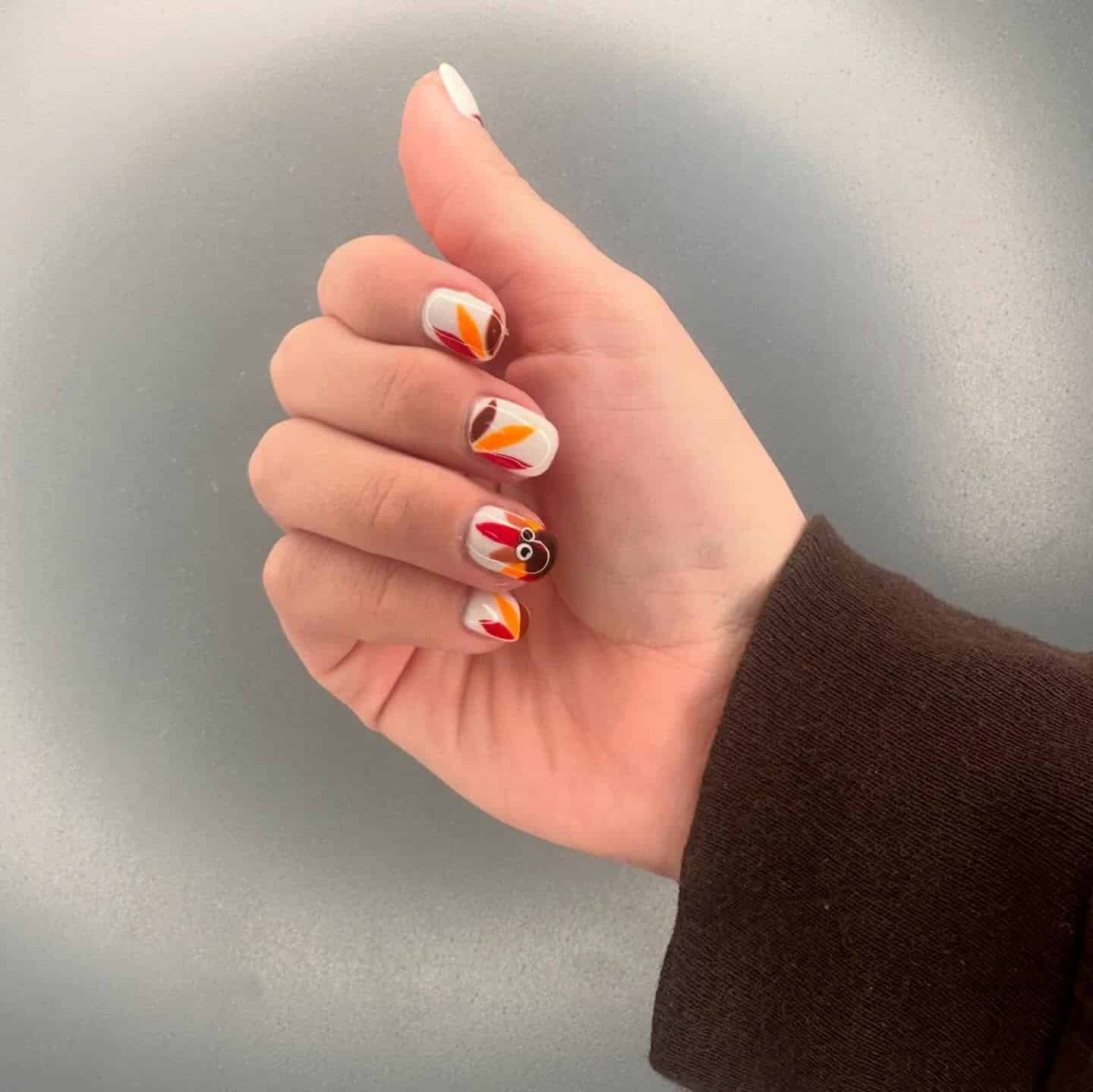 19. Cartoon Turkey Nail Art with Autumn Feather Designs - turkey nail ideas
