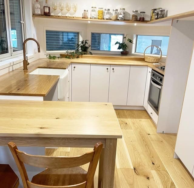 7. Streamlined White Kitchen With Light Oak Counters - tiny house kitchen ideas
