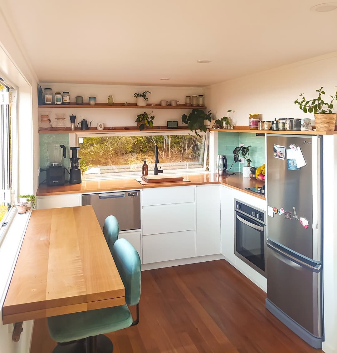 11. Soft White Kitchen With Mint Tile and Warm Wood Counters - tiny house kitchen ideas