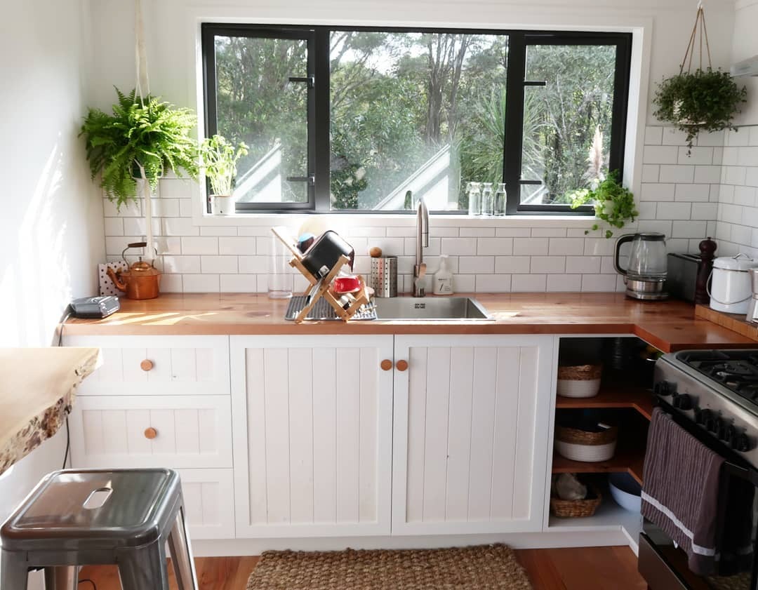 12. Classic White Cottage Kitchen With Natural Timber Counters - tiny house kitchen ideas