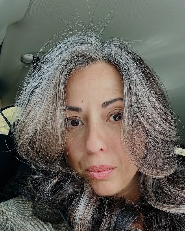 5. Voluminous Charcoal-and-White Blend with Swooped Layers - Gray Hairstyles for Women