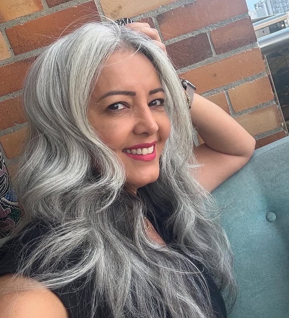 6. Long Dimensional Silver Curls with Soft Parting - Gray Hairstyles for Women