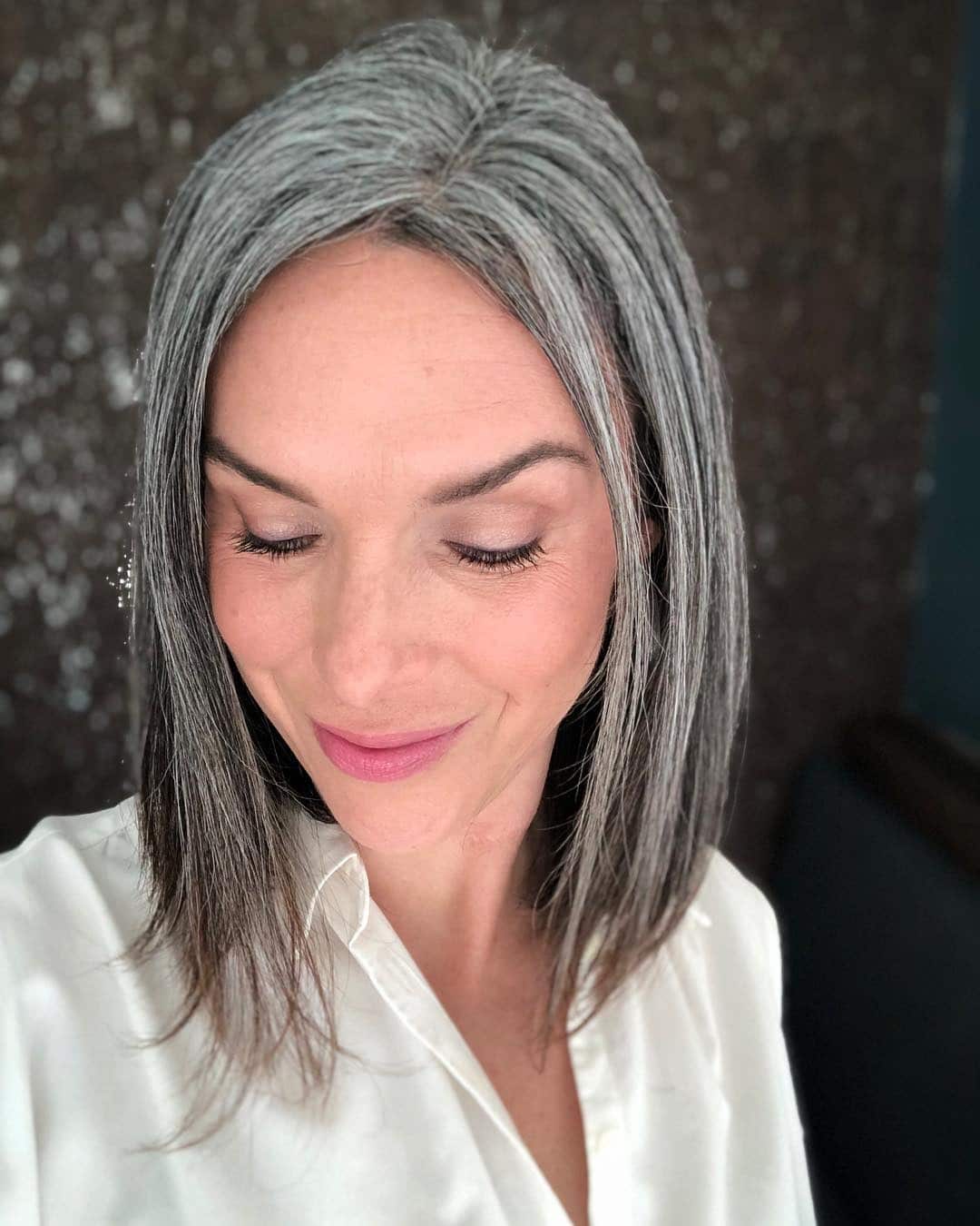 11. Sleek Medium-Length Gray Blend with Center Part - Gray Hairstyles for Women
