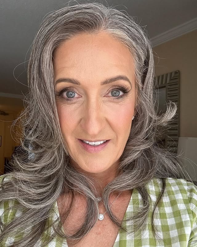 13. Feathered Gray Volume with Swept-Back Layers - Gray Hairstyles for Women