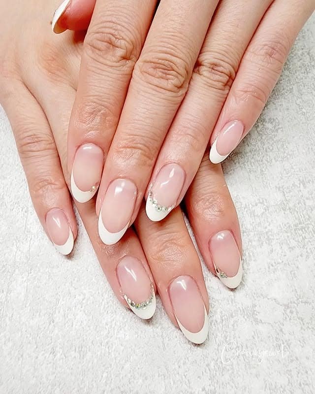 2. Soft Almond French with Crystal Accents - white french nail ideas