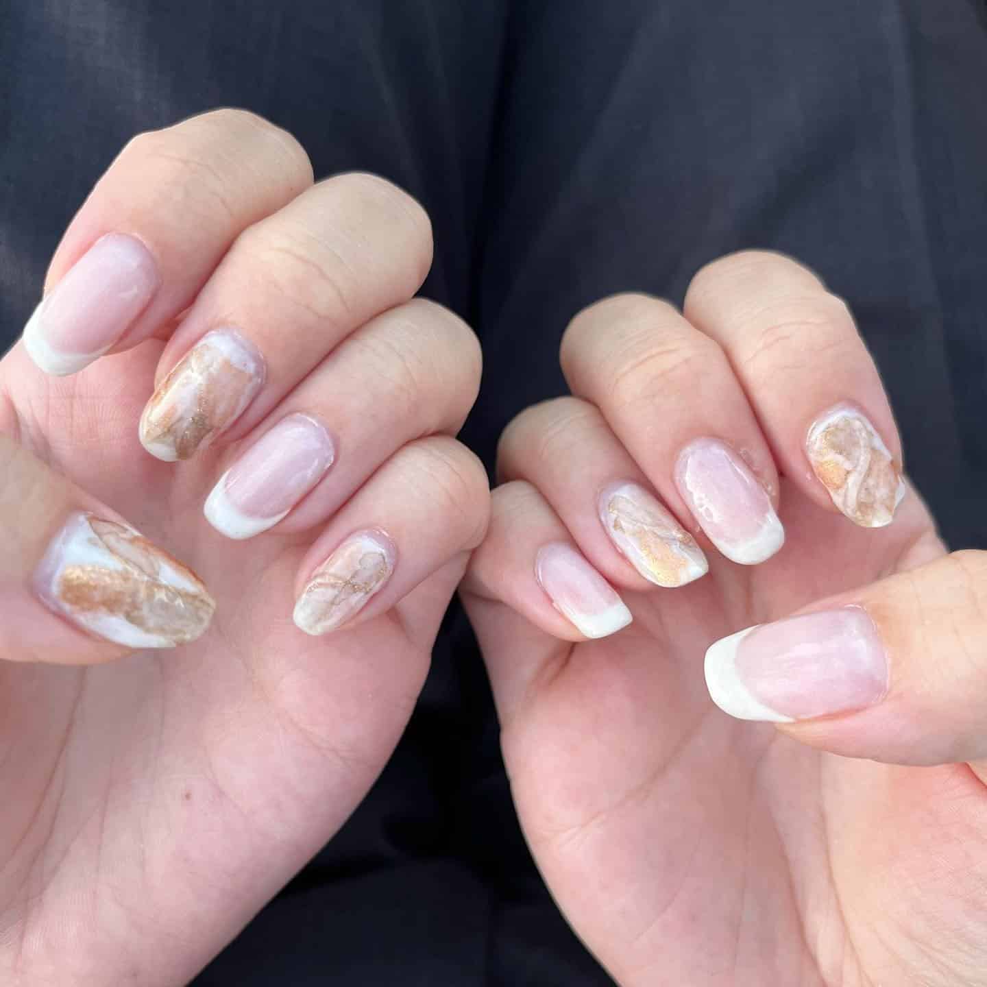 18. Marble Accent French with Warm Tones - white french nail ideas