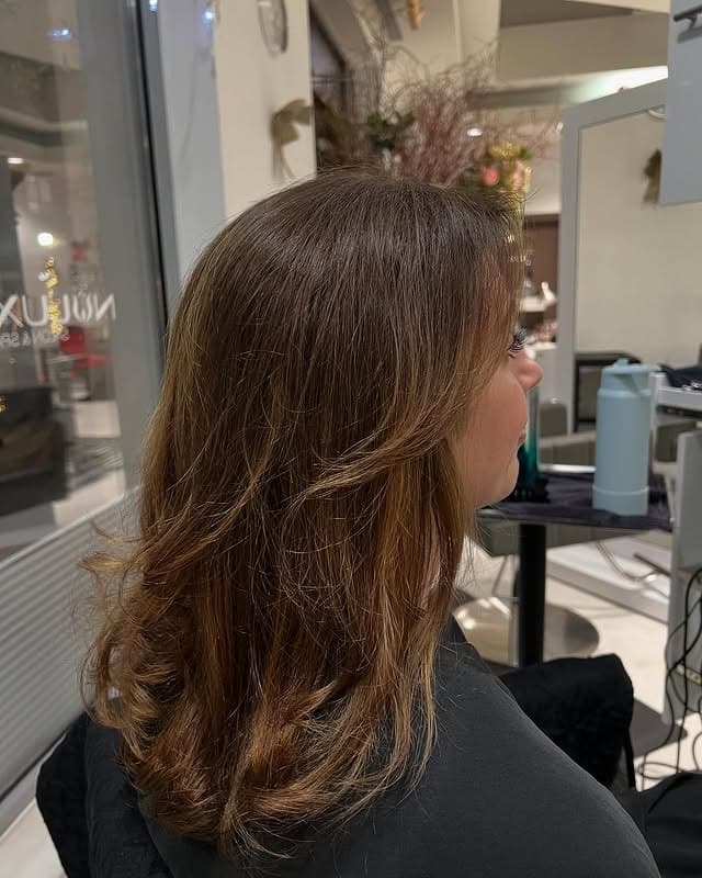 14. Soft Caramel Feathered Layers - Medium-Length Layered Haircuts