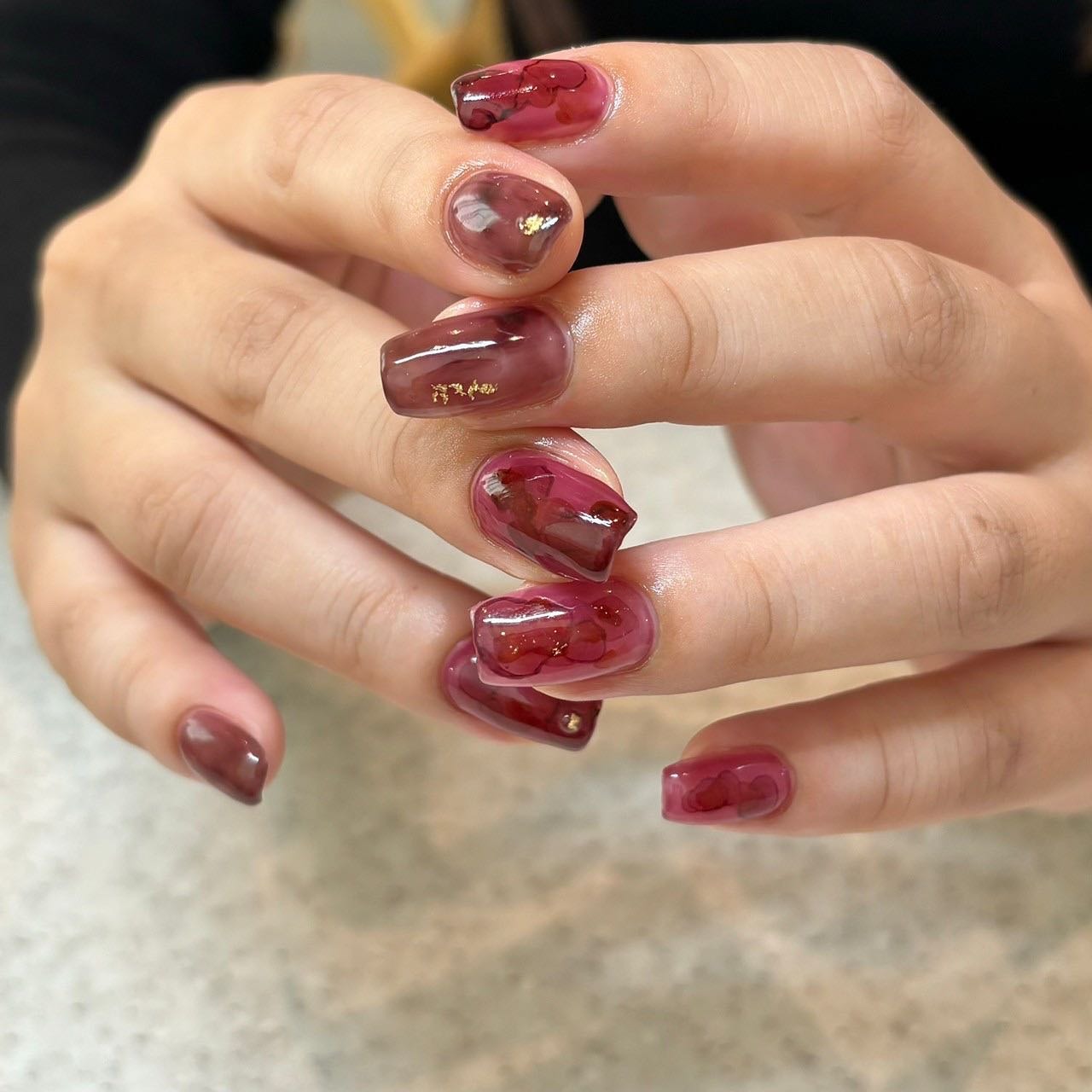 9. Marbled Wine Artistry - wine color nail ideas