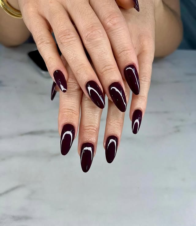 15. Glossy Dark Wine Almond Curve - wine color nail ideas