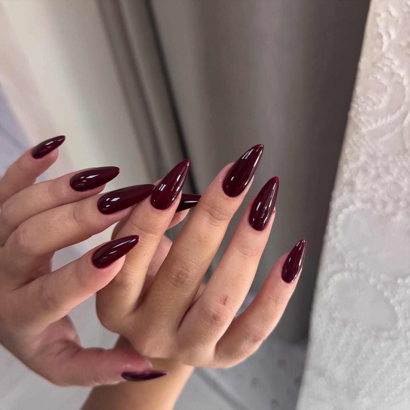 21. Glossy Deep Wine Stiletto - wine color nail ideas