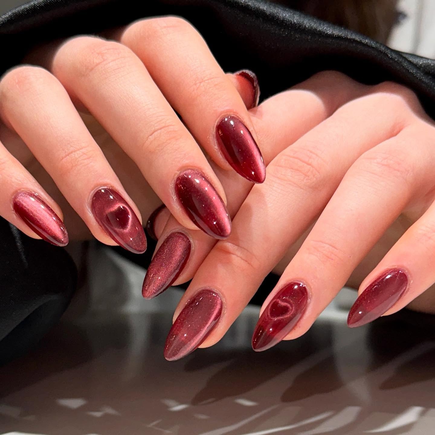 22. Shimmer Wine Cat-Eye Almond - wine color nail ideas