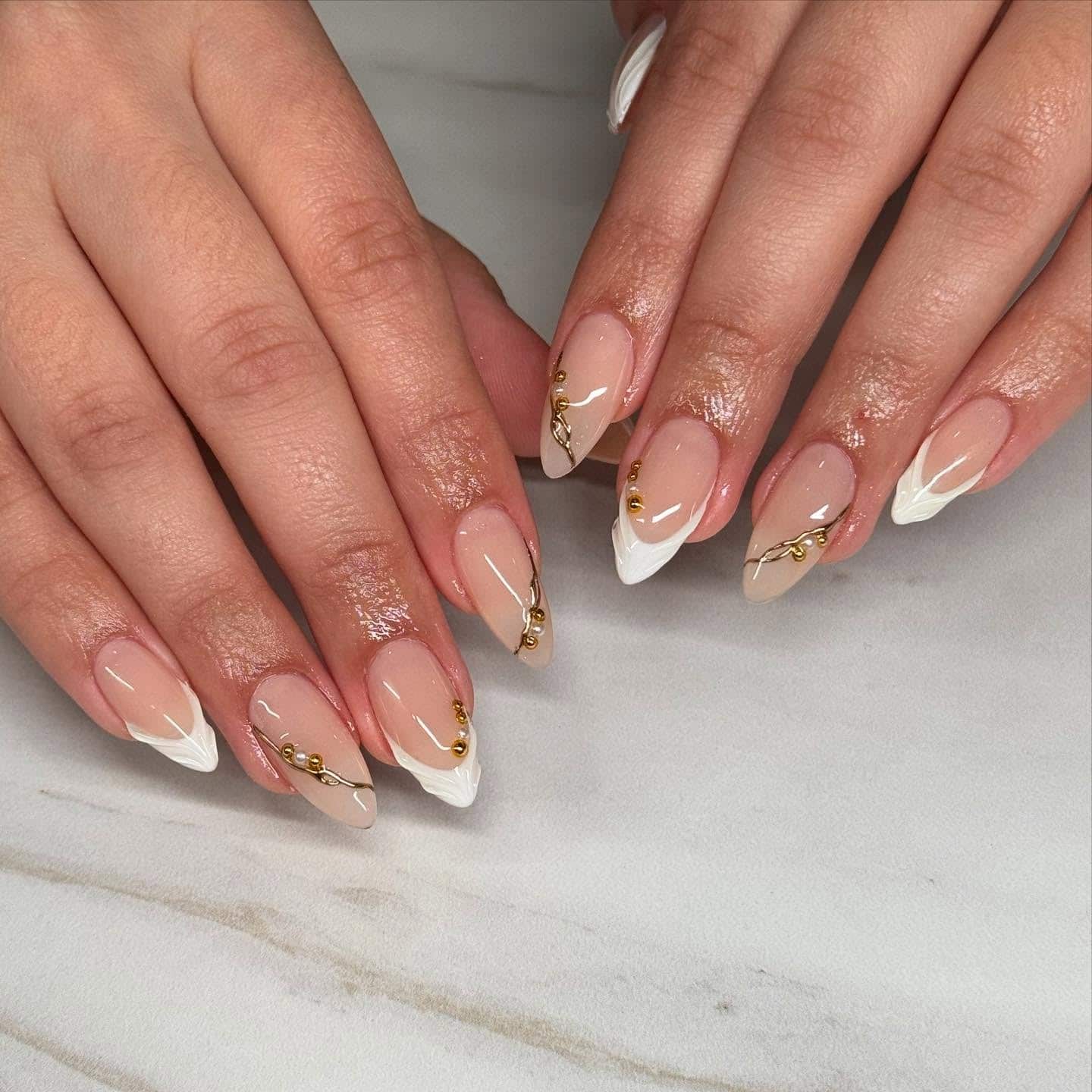15. White Textured Almond Tips with Gold Detailing - almond french tip nail ideas