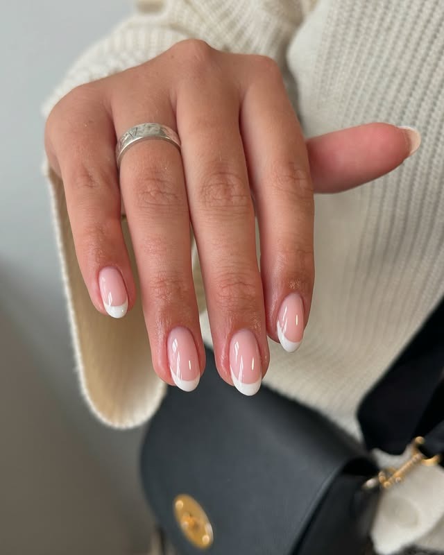 22. Soft Rounded Almond French Tips in Classic White - almond french tip nail ideas