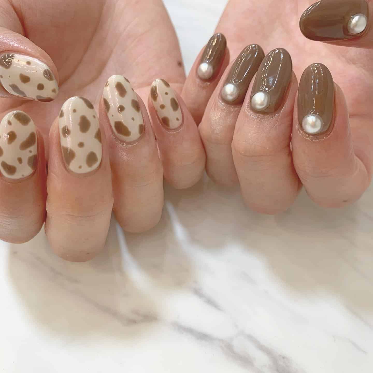 12. Mocha Cow Print With Pearl Details - animal nail ideas