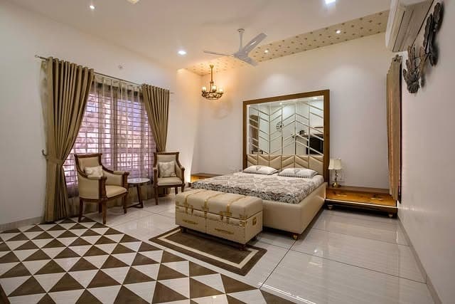 10. Gold-Trim Contemporary Suite with Mirror Feature Wall - royal bedroom ideas