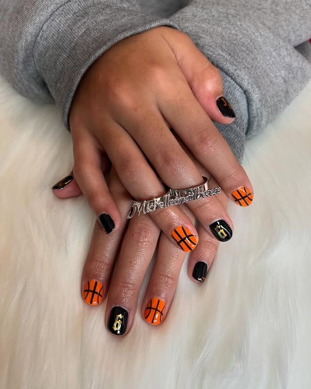 1. Black & Orange Court Accent Nails - basketball nail ideas