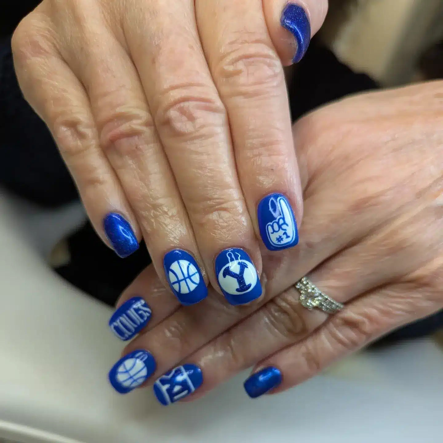 8. Blue Fan Favorite Emblem Nails - basketball nail ideas