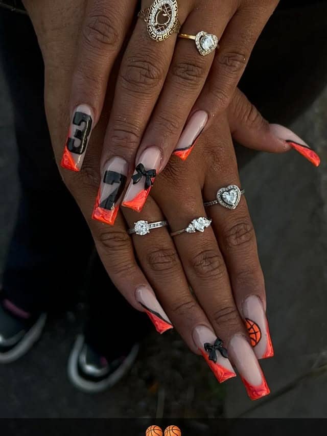 20. Neon Orange French Tips with Bow & Number Art - basketball nail ideas