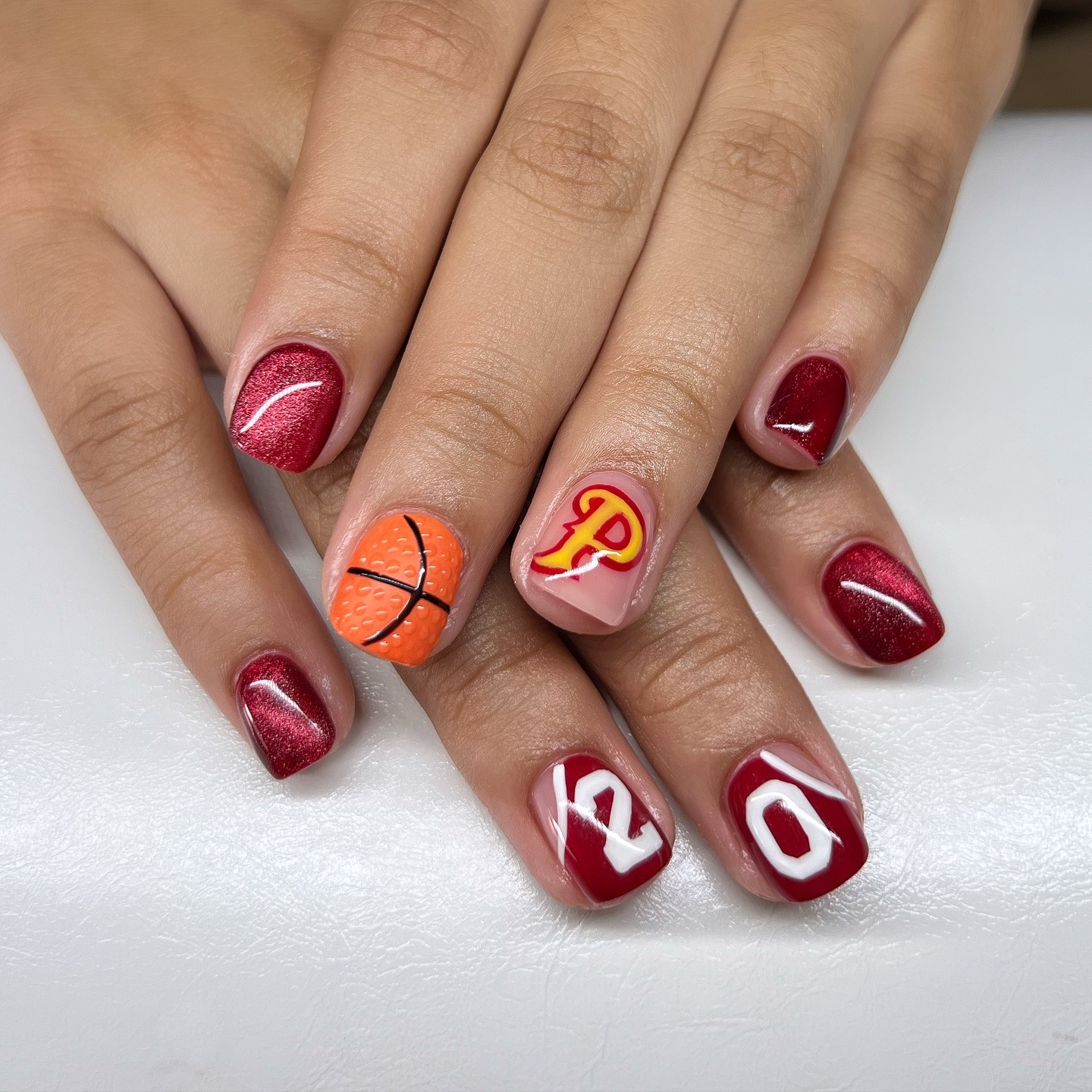 22. Maroon Game Spirit with Textured Basketball Accent - basketball nail ideas