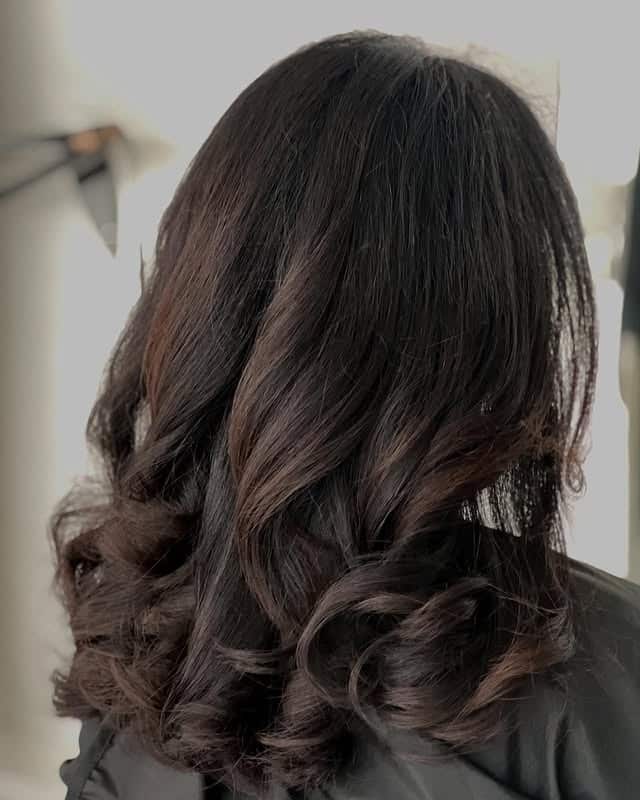 5. Dark Chocolate Layered Curls With Subtle Shine Lights - Balayage Dark Brown Hair Color