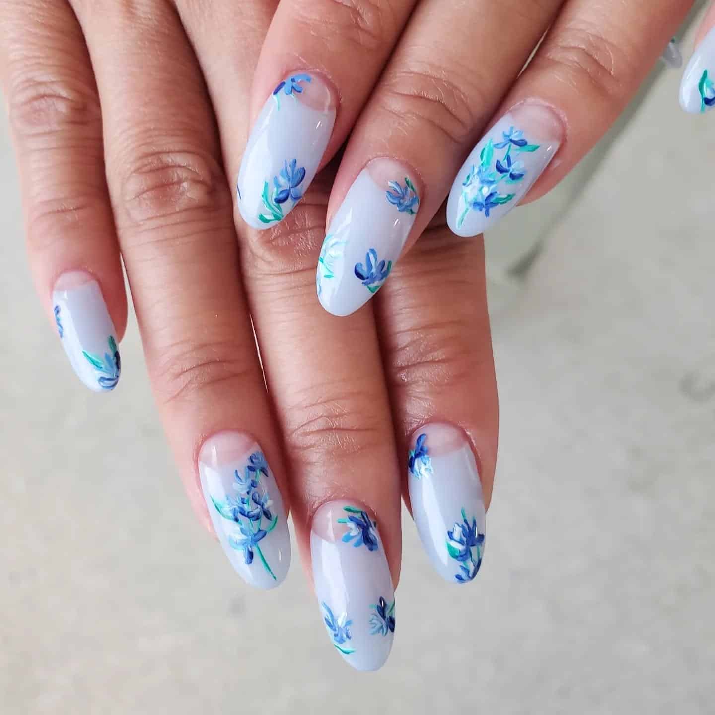 5. Blue Watercolor Florals on Pale Lavender Nails - blue flower nail ideas