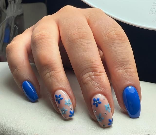 6. Bright Blue and Glitter-Accented Floral Mix - blue flower nail ideas