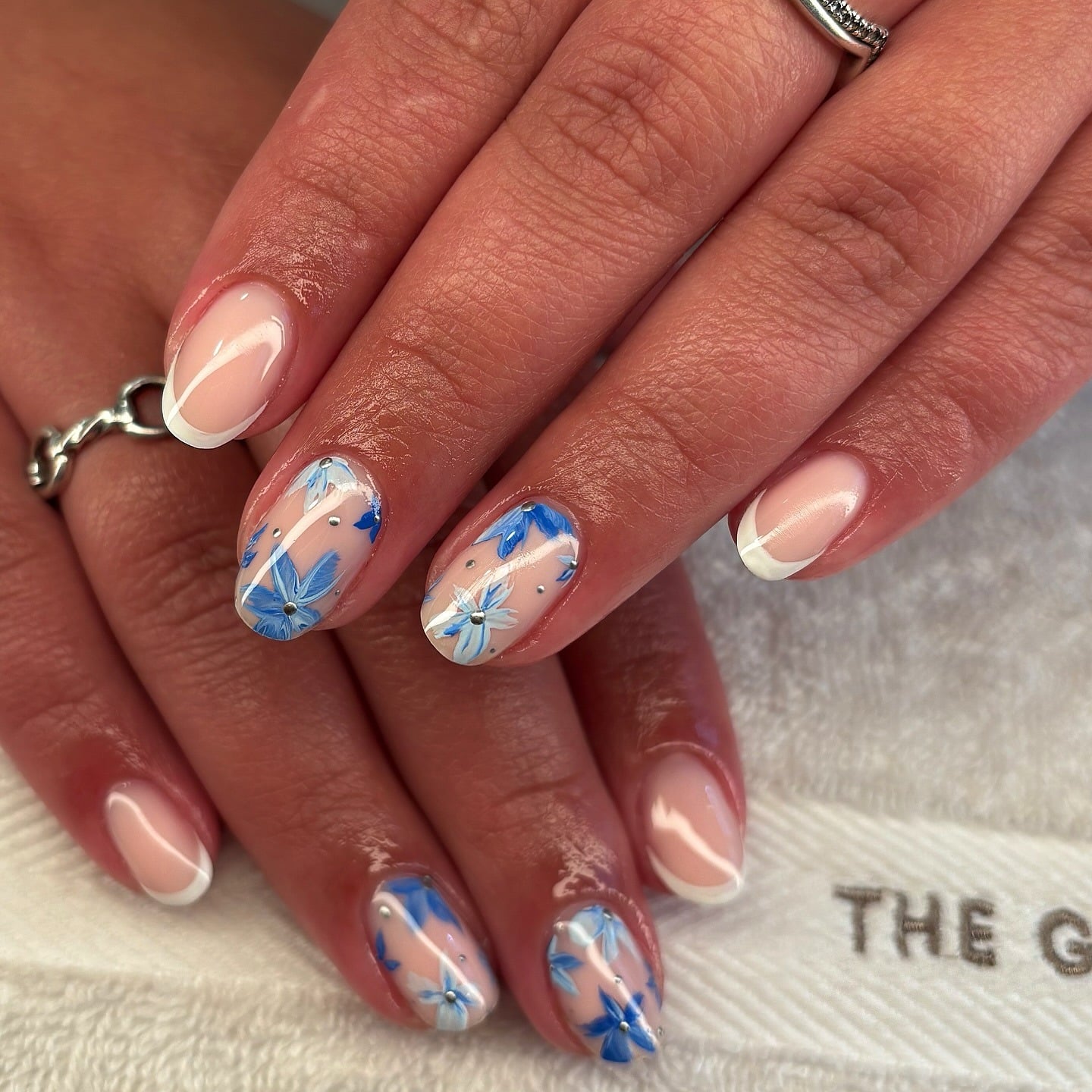7. French Accent Nails with Layered Blue Flowers - blue flower nail ideas