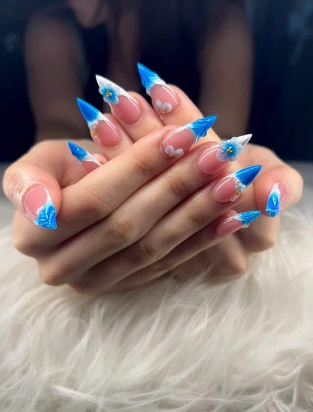 14. Vibrant French Stilettos with Sculpted Floral Accents - blue flower nail ideas