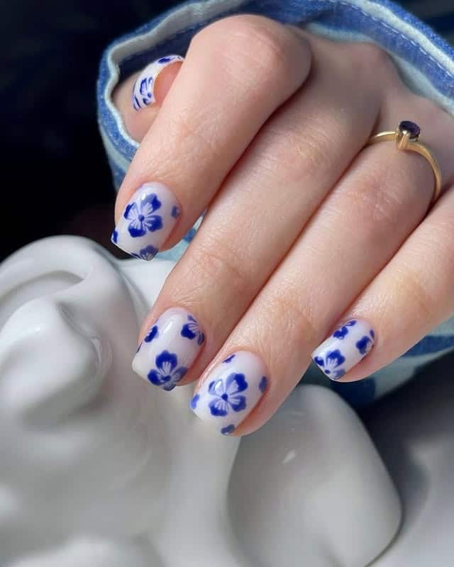 18. Porcelain-Inspired Blue Blossom Nails - blue flower nail ideas