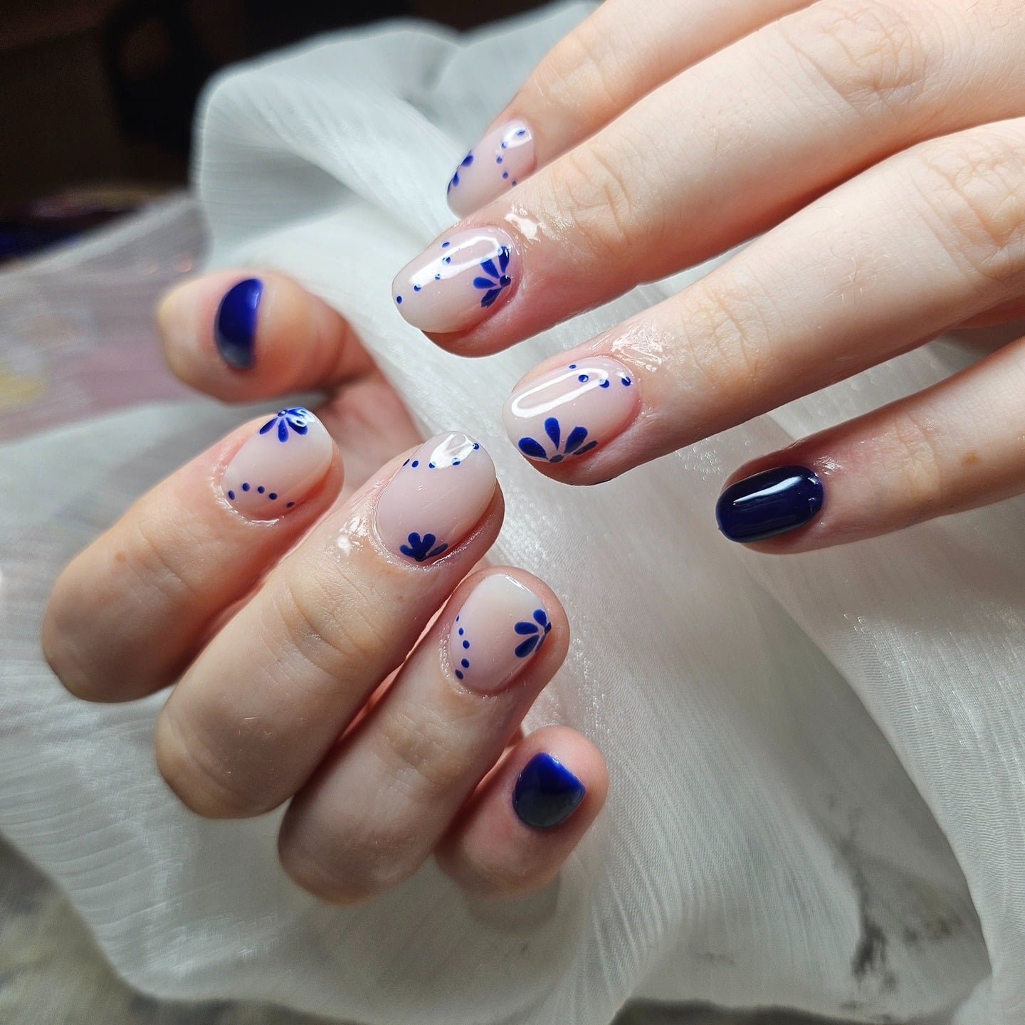 19. Minimal Blue Petal Accents with Navy Feature Nail - blue flower nail ideas