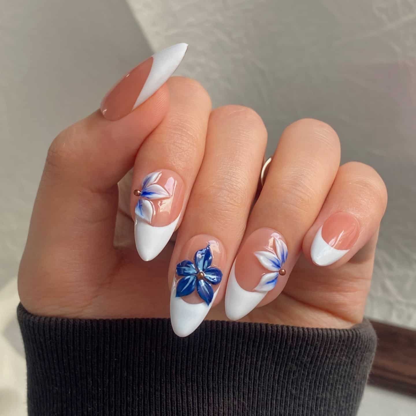 20. White French Almond Nails with Sculpted Blue Florals - blue flower nail ideas