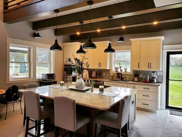 12. Cream Cabinets and Dark Beam Contrast - barndo kitchen ideas
