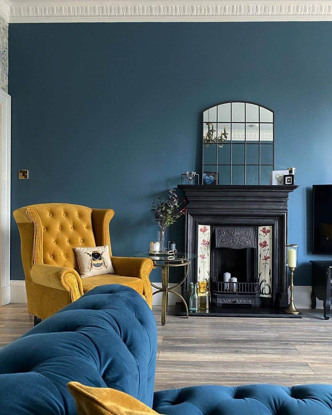 2. Classic Elegance with Rich Blue Walls - yellow and blue living room ideas