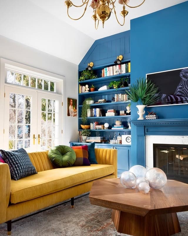 3. Vibrant Built-Ins and a Cheerful Yellow Sofa - yellow and blue living room ideas
