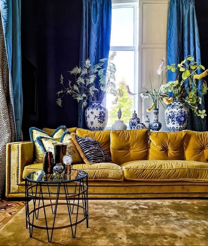 7. Bold Yellow Velvet Against Dramatic Dark Tones - yellow and blue living room ideas