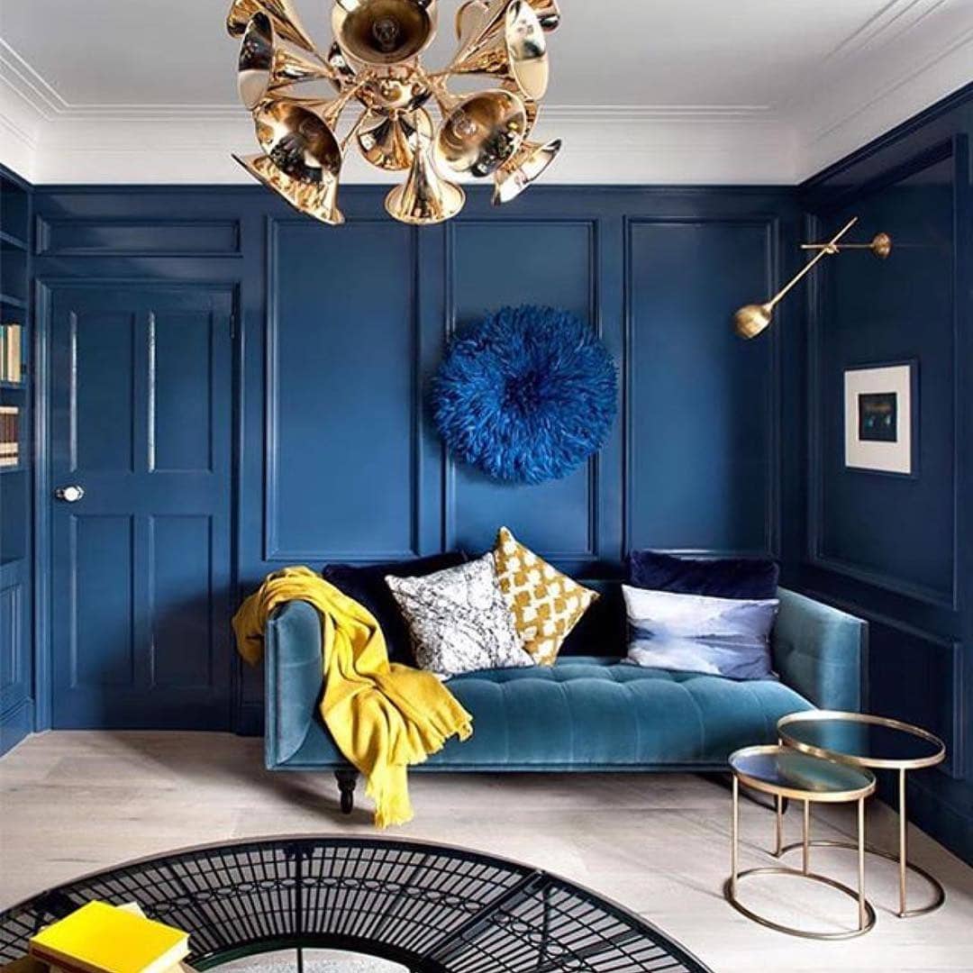 10. Chic Navy Walls with Luxe Metallic Highlights - yellow and blue living room ideas