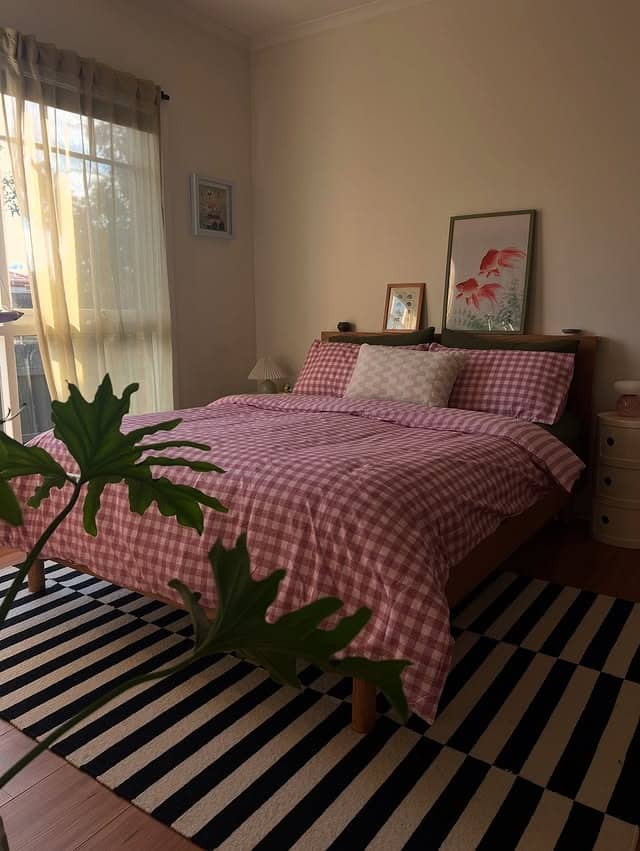 10. Playful Checks and Bold Stripes in Soft Pink - mid century bedroom ideas