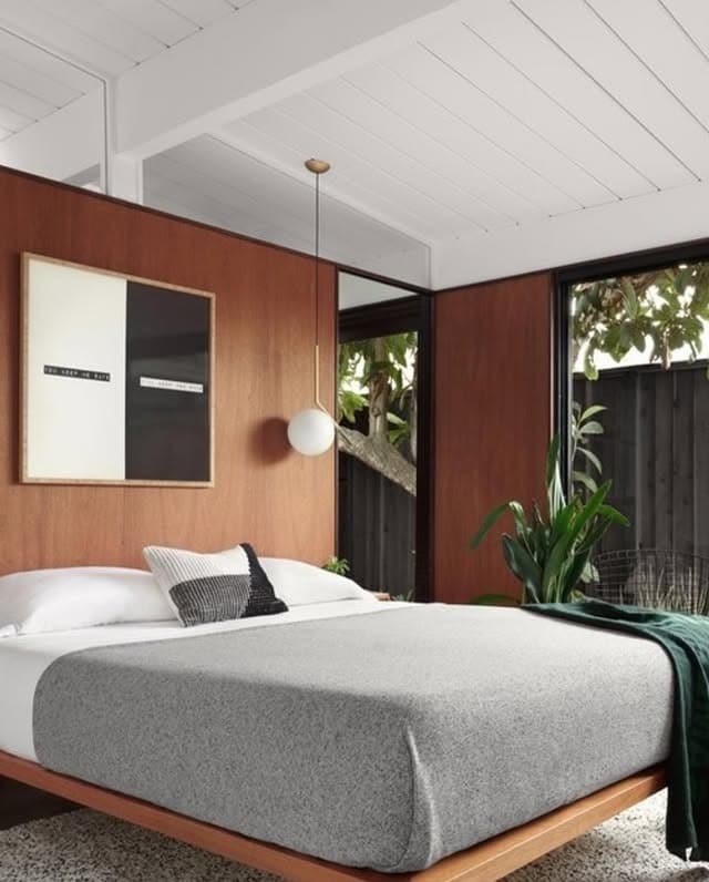 18. Modernist Contrast With Warm Wood Panels - mid century bedroom ideas